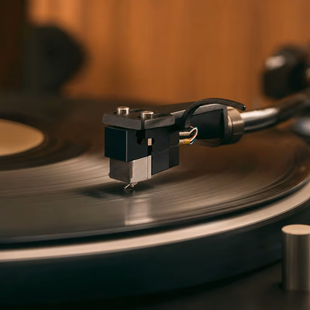 Stylus and cartridge lowering onto a spinning record